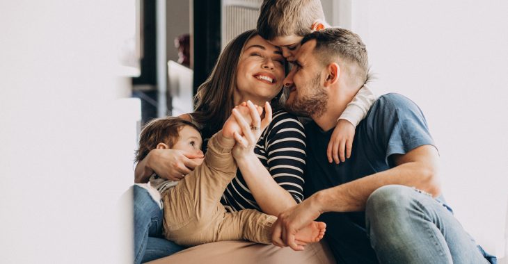 Young family with their sons at home having fun